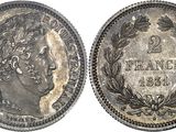 a silver coin with the head of a woman in a wreathed wreath
