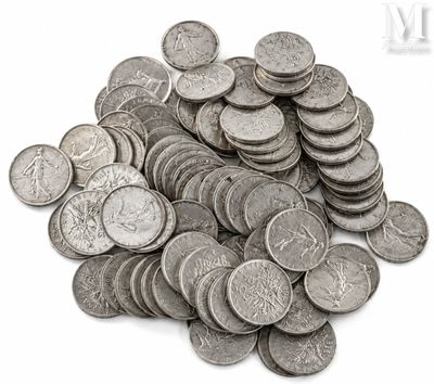 a pile of silver coins sitting on a white surface