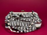 a close up of a zebra print purse on a red surface