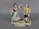 two figurines of a man and a woman on a table