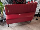 a red bench with a plant on it in a room