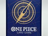 a blue one piece card game with a gold compass on it