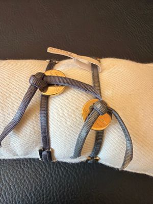 a black and white pillow with a gold button on it