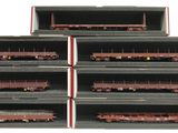 six train cars that are stacked up on a shelf
