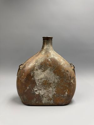 a brown vase that is sitting on a table