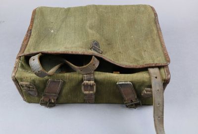 a green bag with a pair of sunglasses inside of it