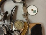 a lot of watches that are laying on a table