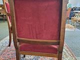 a red chair sitting on a rug in a room