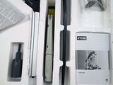a box with a pen, a pencil, a cell phone, and other items in it
