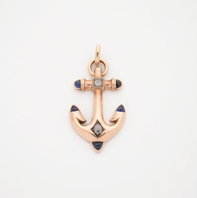 un pendentif en forme d'ancre en or, serti de saphirs bleus et de diamants