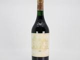 a close up of a bottle of wine on a white surface