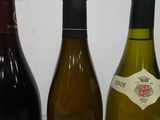 three bottles of wine are lined up on a table