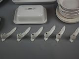 a lot of white plates and bowls on the table