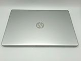the back of a laptop computer sitting on top of a white table