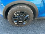 a close up of a tire on a blue car