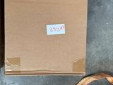 a box and a banana on the floor next to a banana peeler