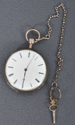 une montre de poche en argent à laquelle est attachée une clé