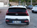 a white car that is parked on the side of the road