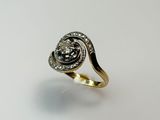 a close up of a gold and diamond ring on a white surface