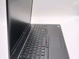 a laptop computer sitting on a table with a keyboard