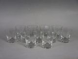 six glasses are lined up in a row on a white surface