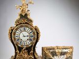 a clock that is sitting next to a bowl