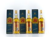 three bottles of whisky with boxes on a white surface
