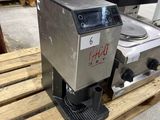 a close up of a coffee machine on a pallet in a warehouse