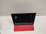 a red tablet computer sitting on top of a white table