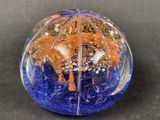 an image of a blue and orange glass ball with a palm tree inside