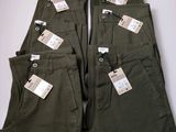 five pairs of pants with tags on them sitting on a table