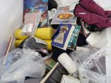 many items that are in a plastic bag on the bed