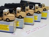 five toy army trucks that are lined up on a table