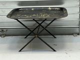 a metal tray on a small table on a metal stand
