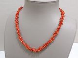 a necklace made of coral coral beads on a mannequin