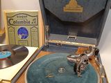 an old record player sitting on top of a wooden table