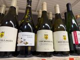 several bottles of wine are on a shelf in a store