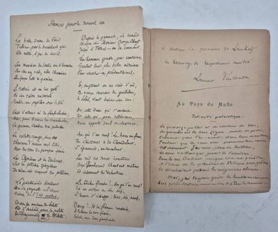 two old papers with writing on them sitting on top of a table