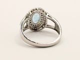 an image of a silver ring with a blue stone in the center