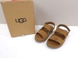 brown ugg sandal with open toe and box on white surface