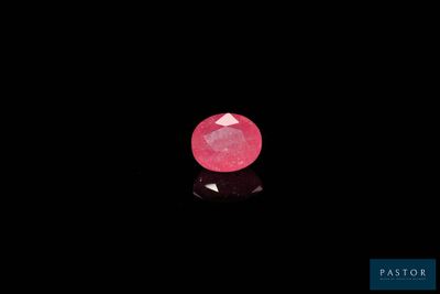 a pink diamond on a black surface