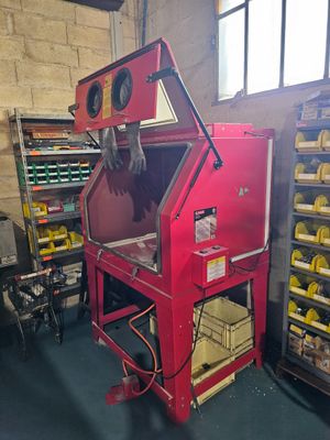 a red machine that is sitting in the middle of a room