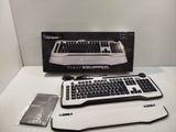 a computer keyboard and mouse sitting on a table