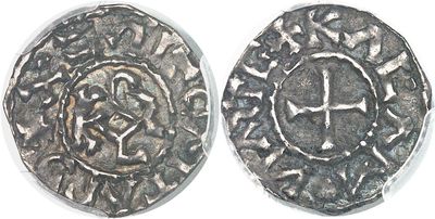 a close up of two silver coins on a white surface