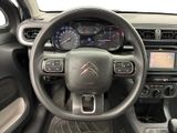 the interior of a car with a steering wheel and dashboard controls
