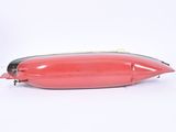 a small red object that is sitting on a white surface
