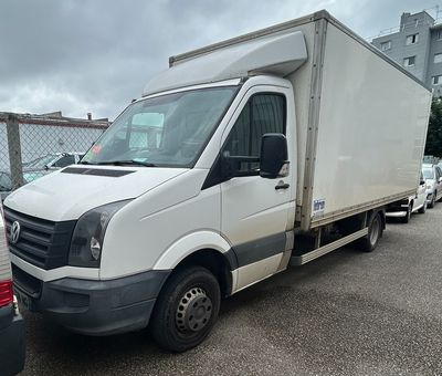 a white truck that is parked next to a white van