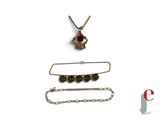 three pieces of jewelry including a necklace, bracelet, and broochet