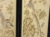 two framed pictures of birds and flowers in a room