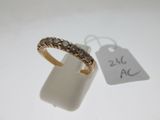 a gold ring with black diamonds on it next to a price tag
